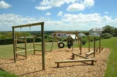 Young children enjoy the play area behind our two self catering cottages