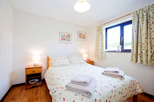One of Bramblewood's two double bedrooms, this one overlooks the garden
